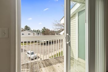 A white car is parked in a driveway.